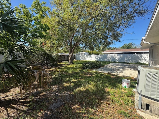 view of yard with a patio, a fenced backyard, and central AC