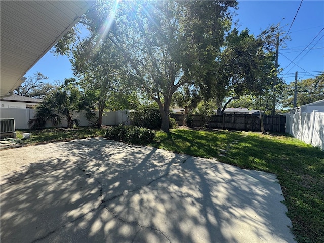 exterior space featuring central AC and a fenced backyard