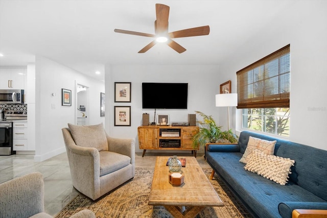 living area with recessed lighting, a ceiling fan, and baseboards