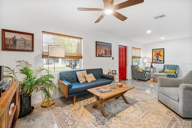 living area featuring a wealth of natural light, visible vents, recessed lighting, and a ceiling fan