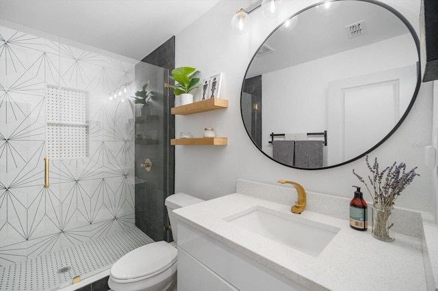 full bath featuring visible vents, toilet, vanity, and a tile shower