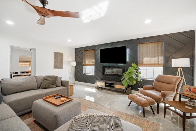 living area featuring recessed lighting, marble finish floor, and ceiling fan