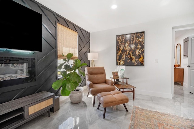 living area with recessed lighting, baseboards, and marble finish floor