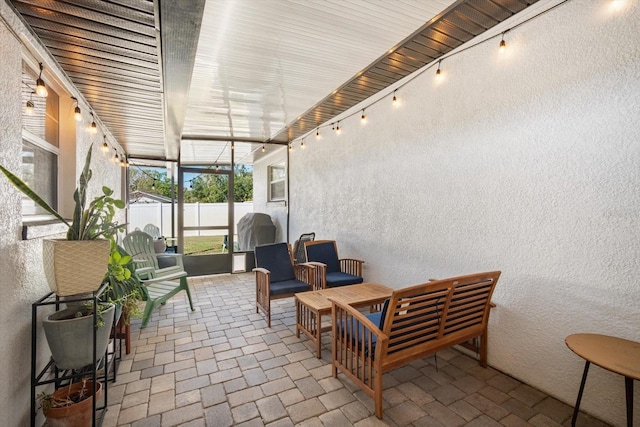 sunroom featuring rail lighting