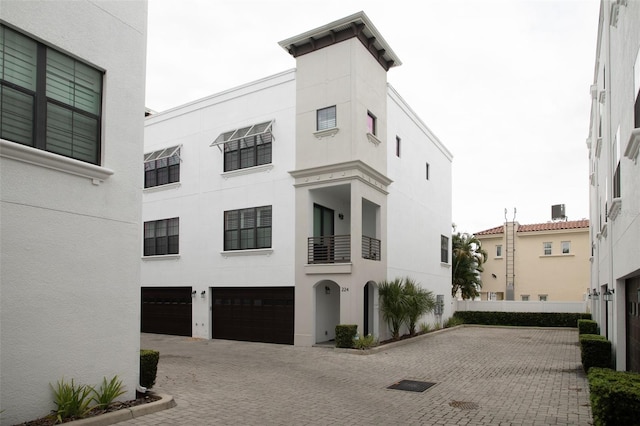 view of property with an attached garage and driveway