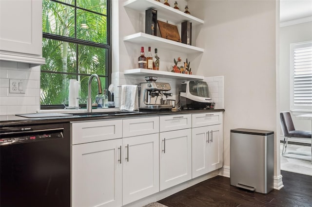 bar with dark wood-style flooring, a sink, decorative backsplash, black dishwasher, and crown molding