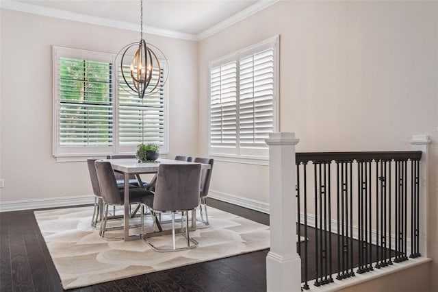 dining space featuring a chandelier, baseboards, wood finished floors, and ornamental molding