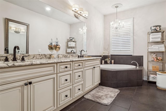 bathroom with a sink, tiled bath, tile patterned flooring, double vanity, and a chandelier