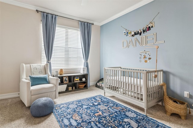 carpeted bedroom featuring a crib, baseboards, and ornamental molding