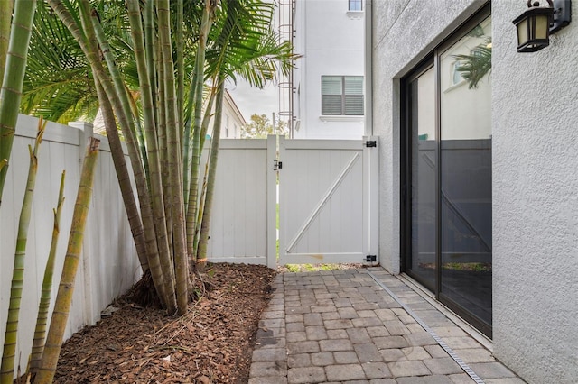 view of patio with a gate and fence