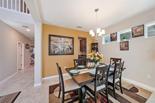 dining space with a chandelier, visible vents, baseboards, and light tile patterned flooring