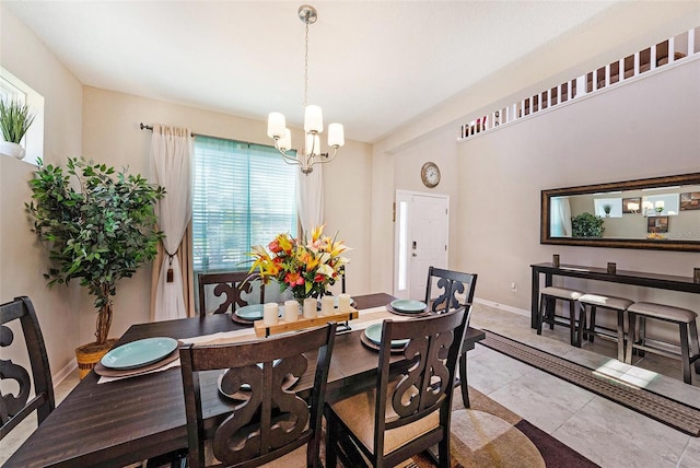 dining room featuring a notable chandelier, baseboards, and light tile patterned floors