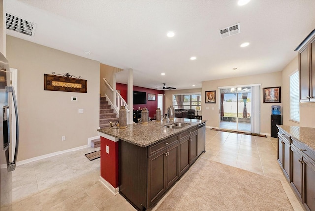 kitchen with light stone counters, visible vents, appliances with stainless steel finishes, and a sink