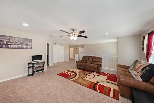 carpeted living area with baseboards, visible vents, recessed lighting, ceiling fan, and a textured ceiling