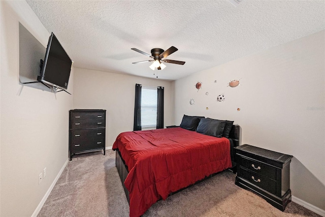 bedroom with carpet flooring, a ceiling fan, baseboards, and a textured ceiling