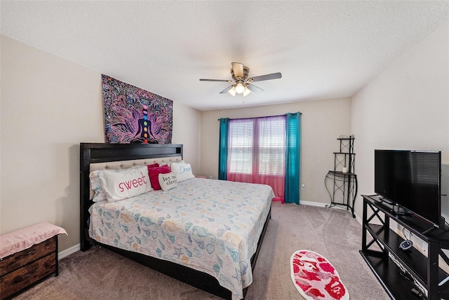 carpeted bedroom featuring ceiling fan, a textured ceiling, and baseboards