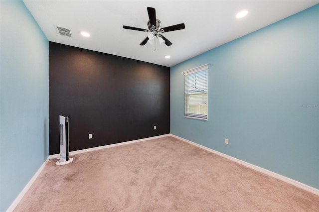 carpeted empty room featuring recessed lighting, a ceiling fan, visible vents, and baseboards