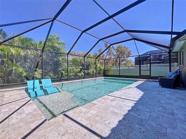 view of pool with glass enclosure, a patio area, and a fenced in pool