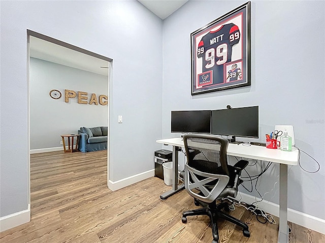 office space featuring light wood-style floors and baseboards