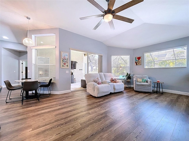 living room featuring vaulted ceiling, baseboards, a ceiling fan, and wood finished floors