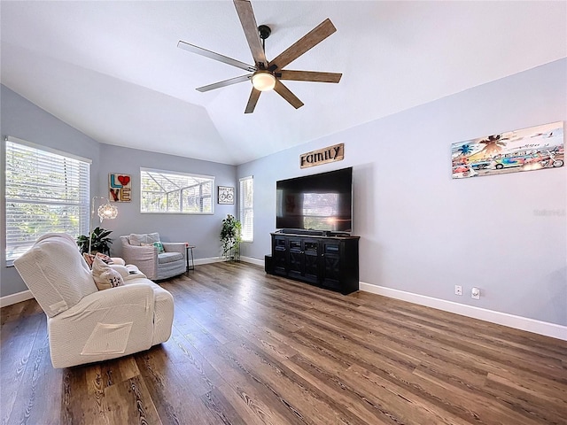 living area with lofted ceiling, wood finished floors, baseboards, and ceiling fan