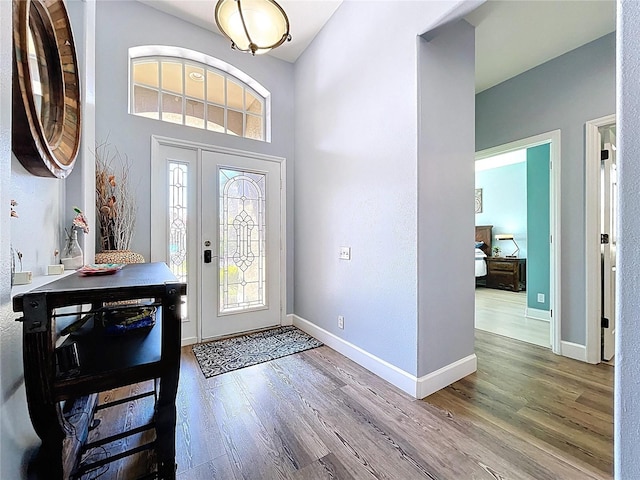 foyer with wood finished floors and baseboards