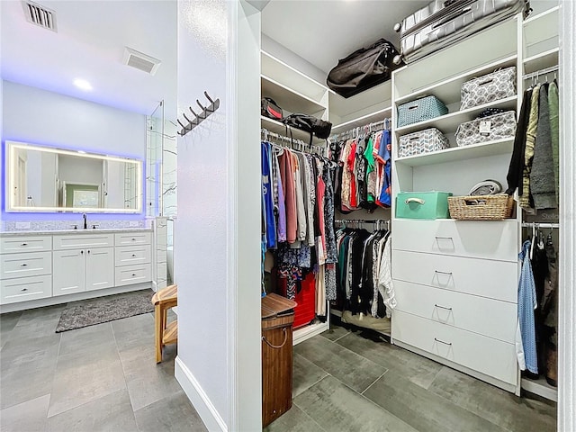 spacious closet with visible vents and a sink