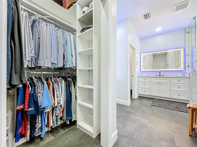 walk in closet featuring visible vents and a sink