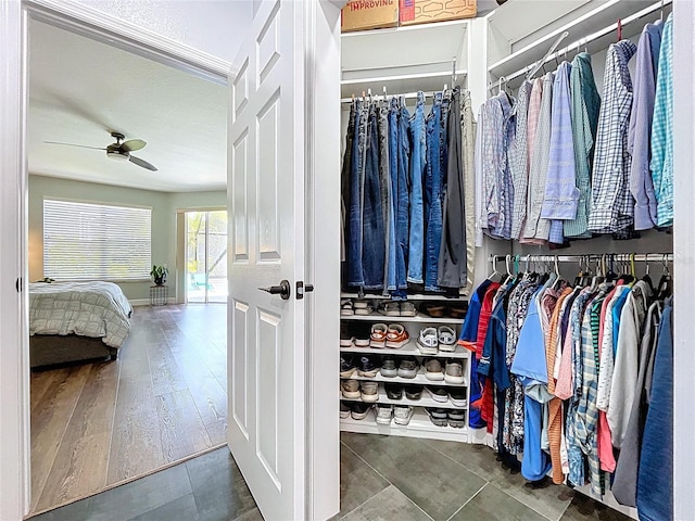 walk in closet with wood finished floors and ceiling fan