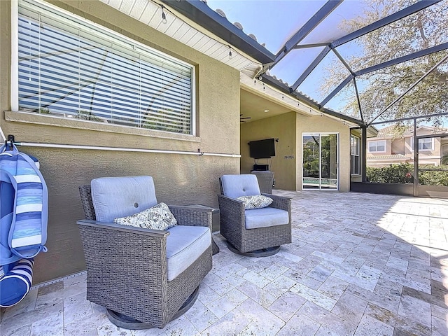 view of patio with glass enclosure