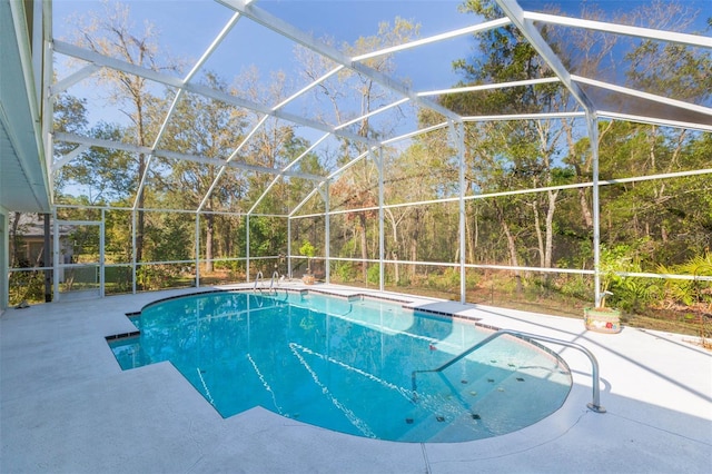 outdoor pool with a lanai and a patio