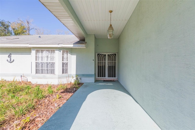 doorway to property featuring stucco siding