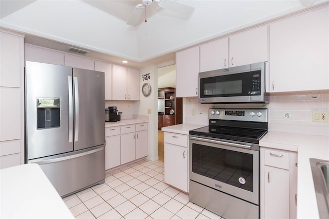 kitchen with stainless steel appliances, decorative backsplash, and light countertops