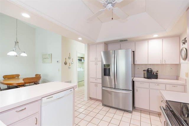 kitchen with washer / dryer, stainless steel fridge with ice dispenser, light countertops, dishwasher, and a raised ceiling