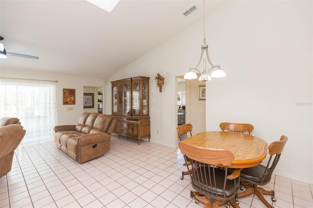 dining area featuring light tile patterned floors, visible vents, baseboards, and lofted ceiling