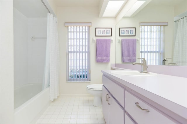 full bath featuring toilet, a skylight, shower / tub combo, tile patterned floors, and vanity