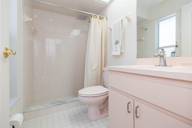 bathroom with tile patterned floors, toilet, vanity, and a tile shower