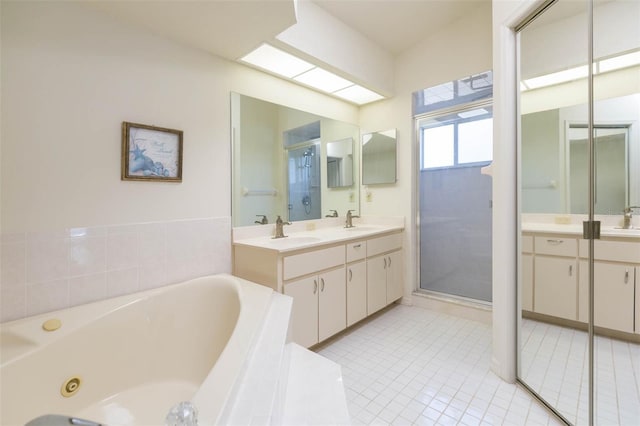 full bath with tile patterned floors, a stall shower, vanity, and a whirlpool tub