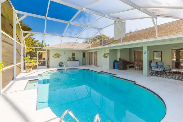 outdoor pool with a lanai and a patio