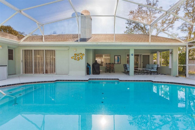 outdoor pool featuring a patio, a lanai, and outdoor lounge area