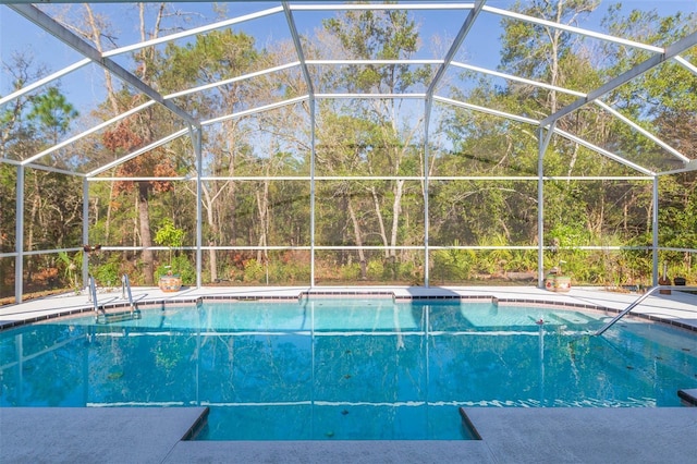 outdoor pool featuring glass enclosure