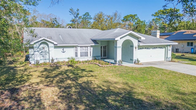 ranch-style home featuring a front yard, an attached garage, concrete driveway, and stucco siding