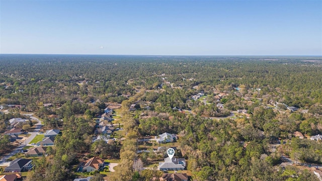 birds eye view of property featuring a wooded view and a residential view