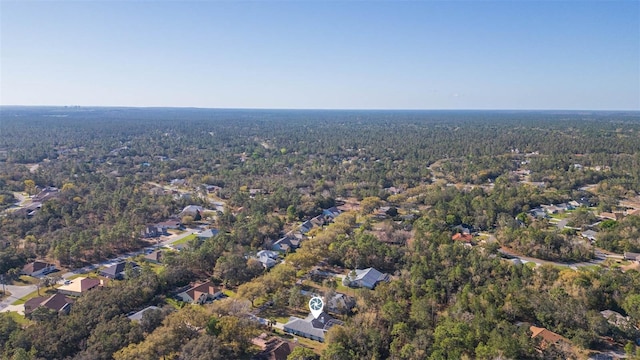 bird's eye view with a wooded view