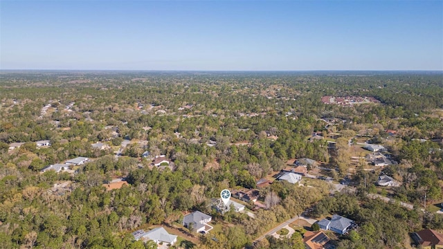 birds eye view of property featuring a wooded view