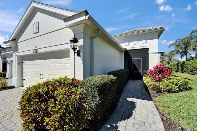 view of front of property with an attached garage and stucco siding