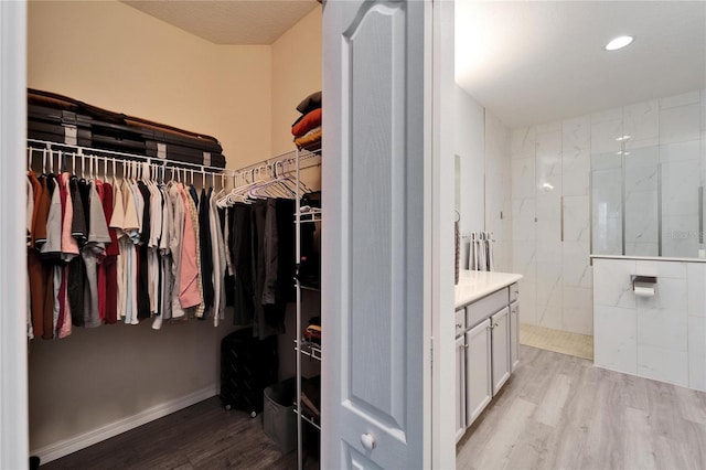 walk in closet featuring light wood finished floors