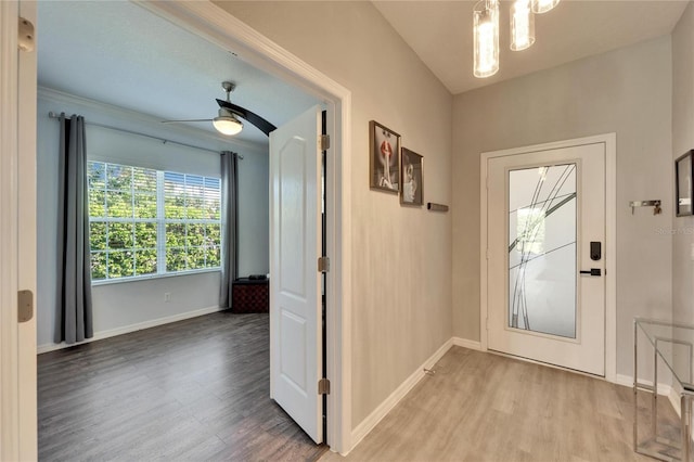 foyer featuring a ceiling fan, wood finished floors, and baseboards