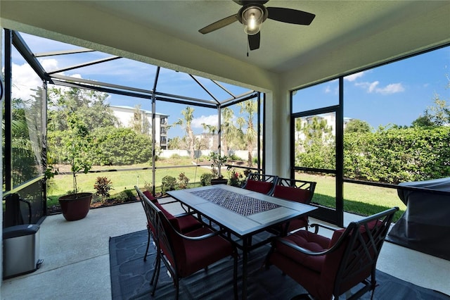 sunroom / solarium featuring ceiling fan