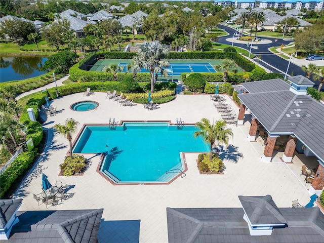 view of pool with a community hot tub and a water view